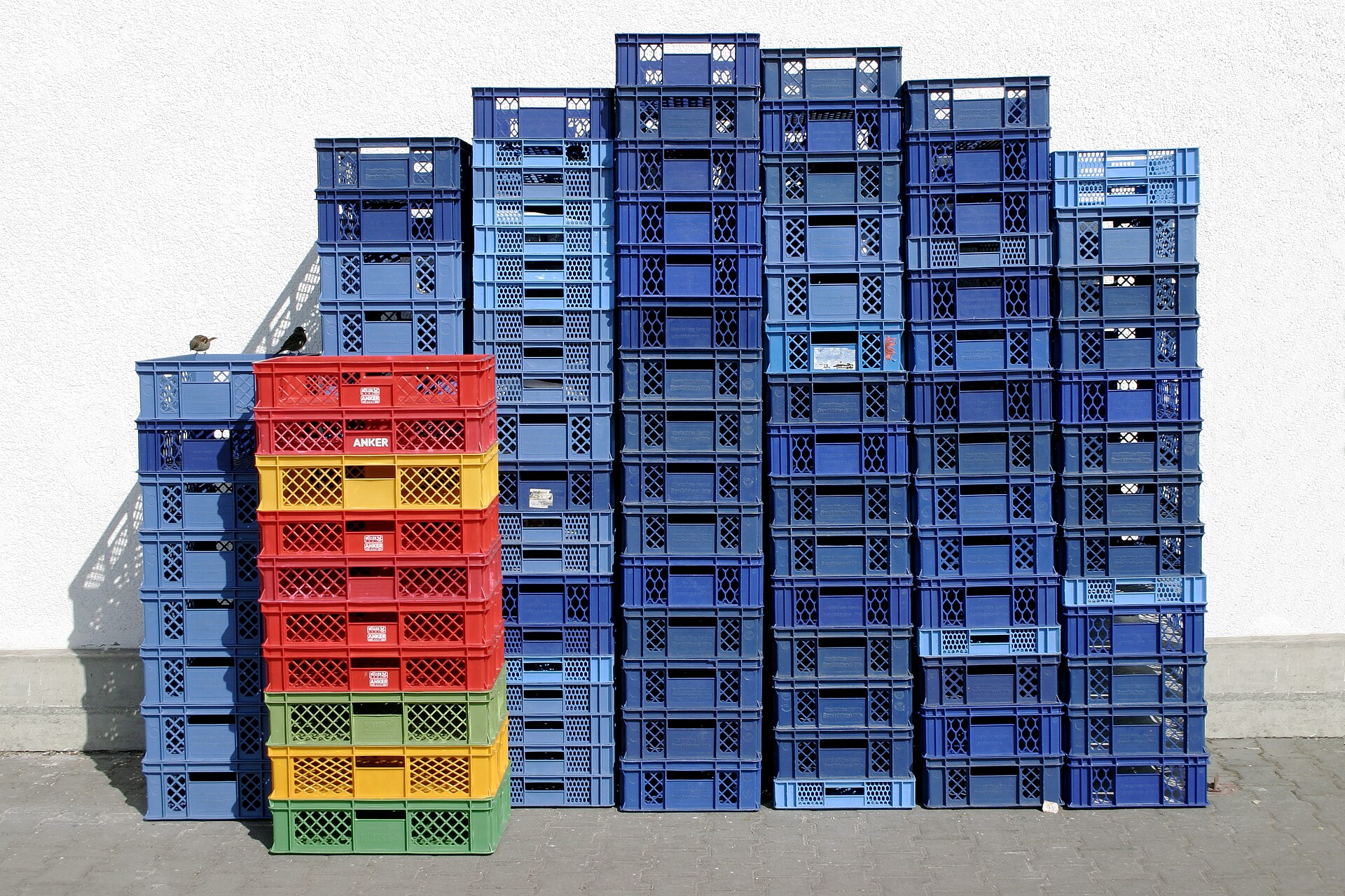 Stacked plastic storage tubs in a warehouse